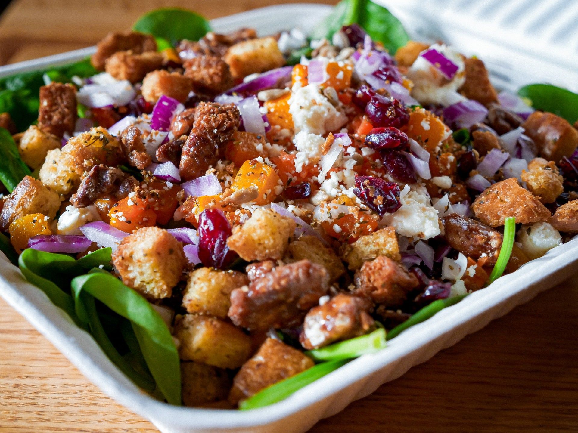 A person is holding a sandwich that has been cut in half.