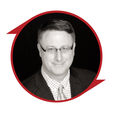 Black-and-white portrait of a man in glasses inside a red circular frame on a black background