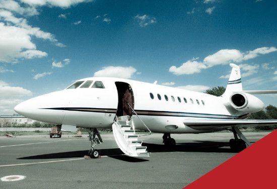 White private jet with open door and stairs on the tarmac under a blue sky