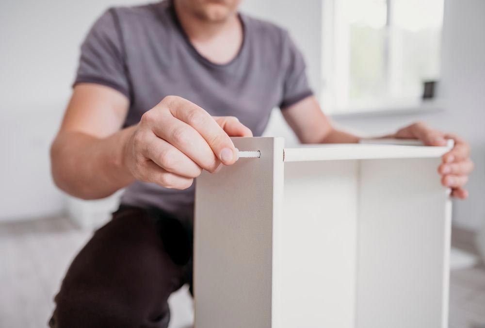 Man Assembling Cabinet