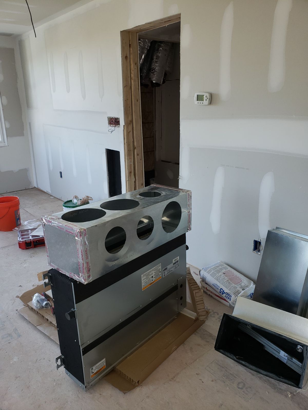 A room that is being remodeled with a stove in it