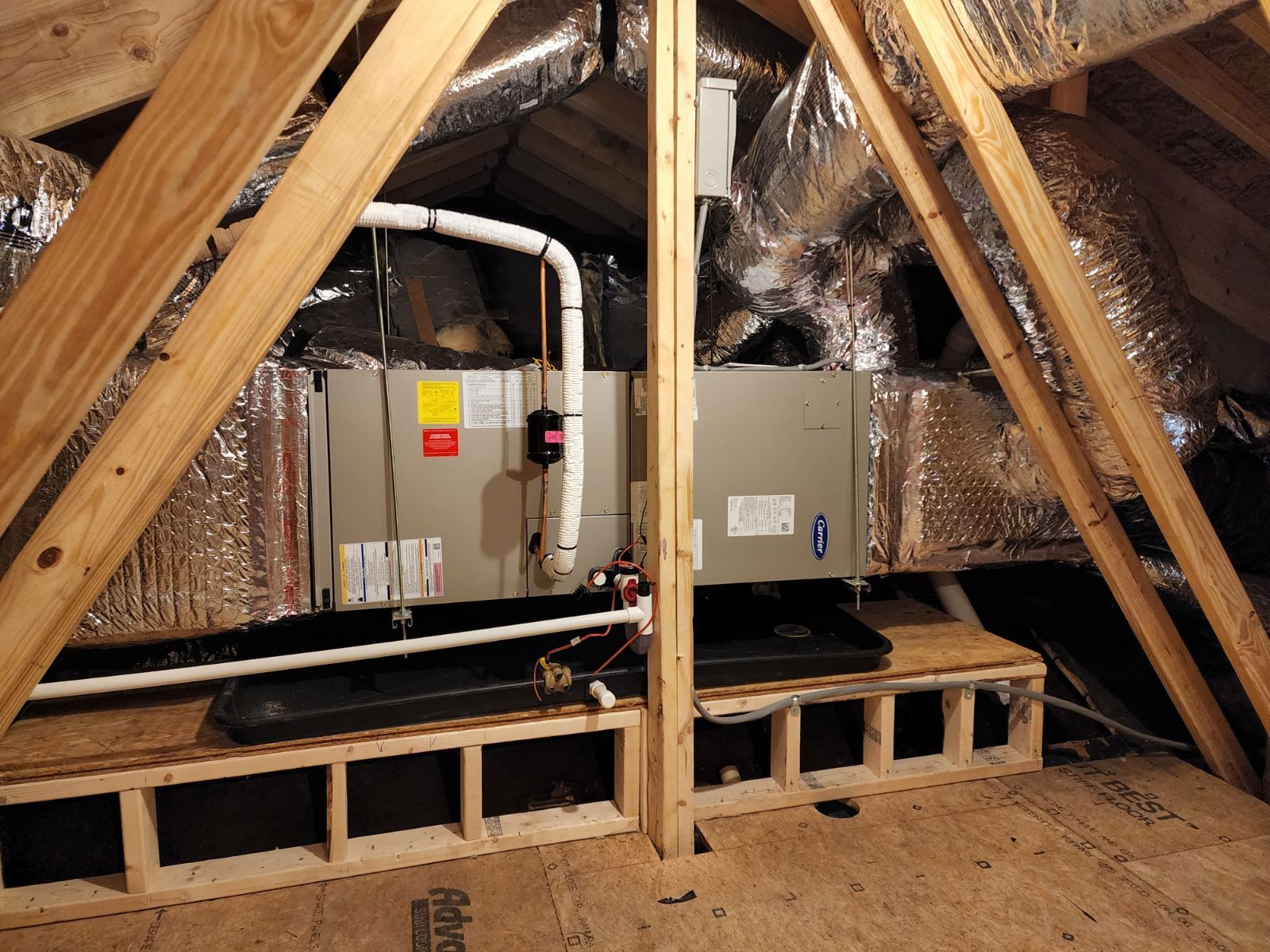 An air conditioner is installed in the attic of a house