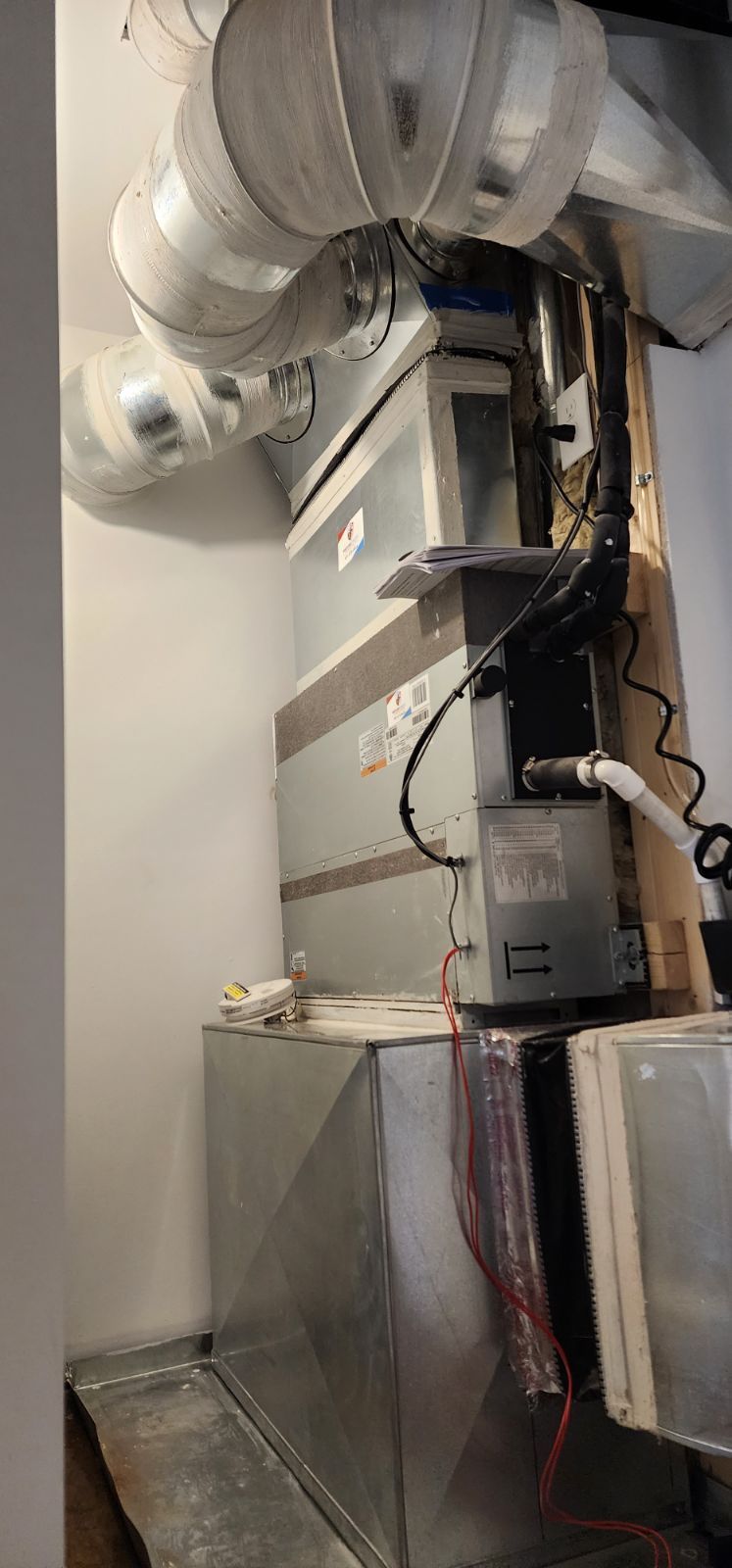 A room with a lot of ducts coming out of the ceiling.