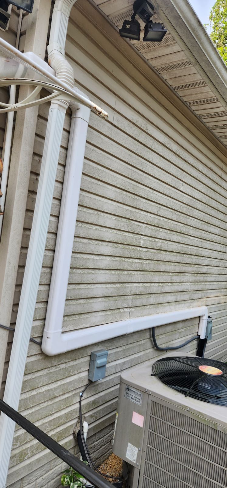 A house with an air conditioner on the side of it.