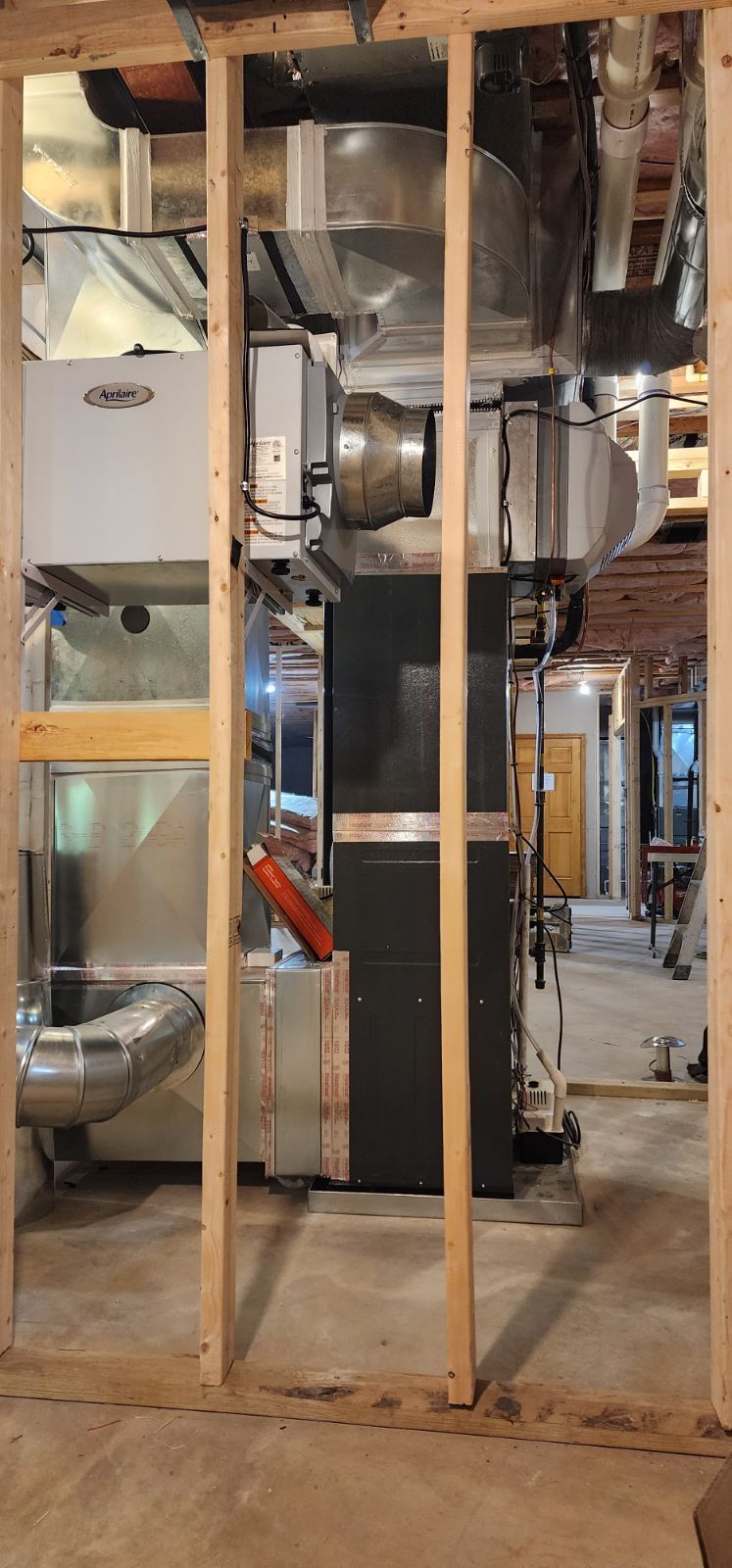 A picture of a basement with a heating system in it.