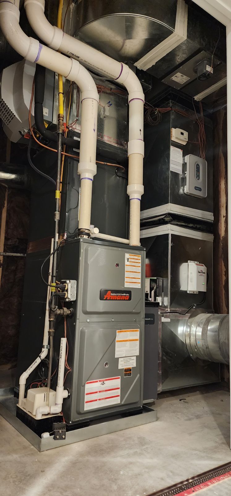 A picture of an air conditioner in a basement.