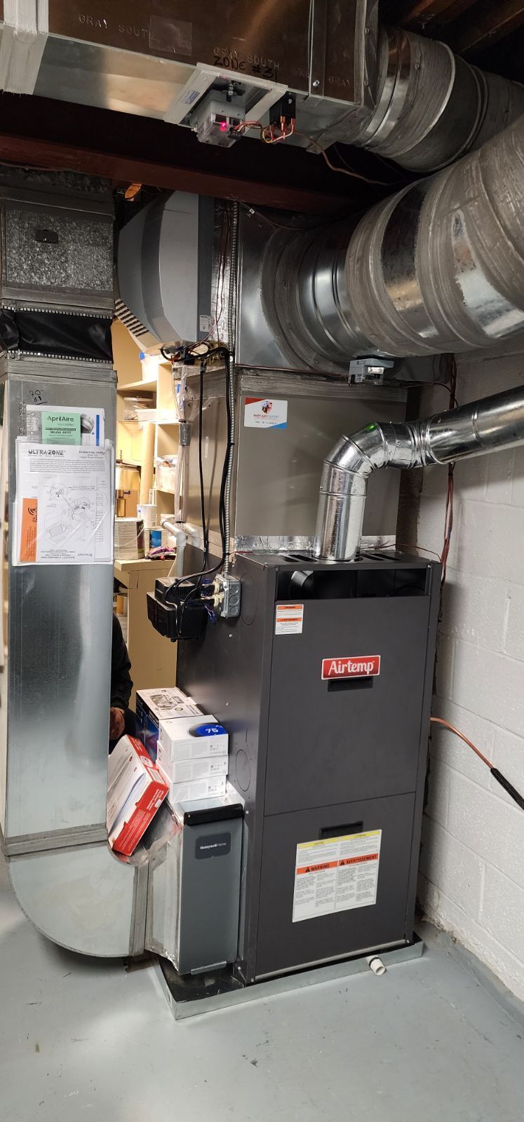 A heating and cooling system is installed in a basement.
