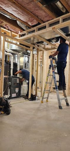 A group of men are working in a basement under construction.