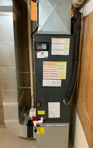 An air conditioner is sitting in a room next to a wall.