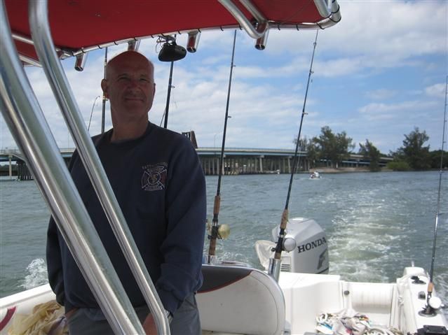 A man on a boat with a honda motor