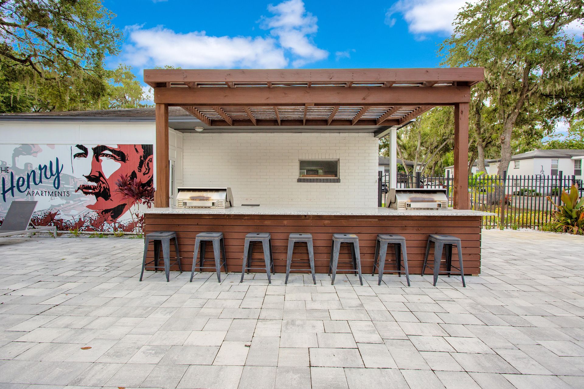 A row of stools are lined up in front of a wooden bar.