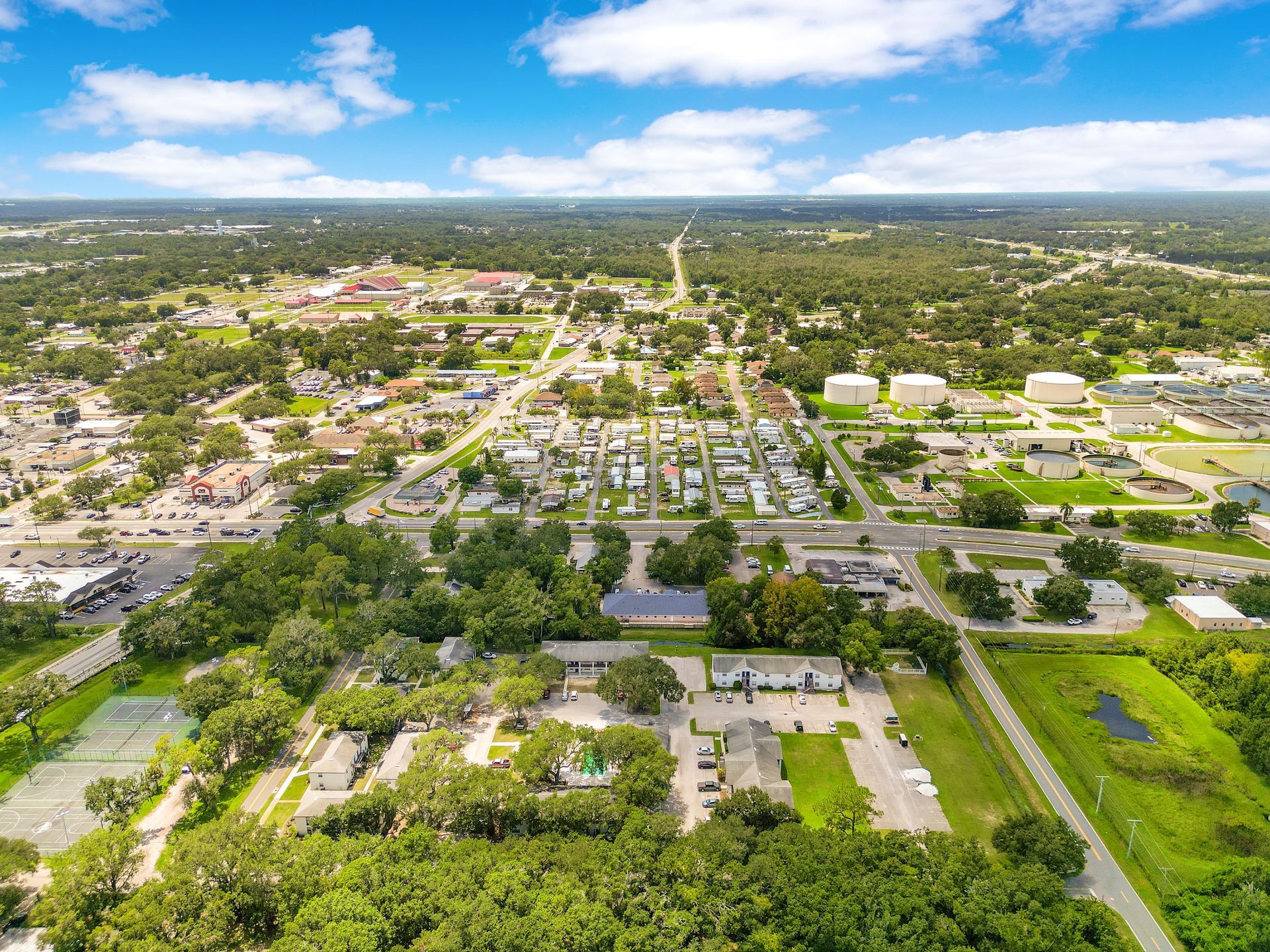An aerial view of a small town surrounded by trees.