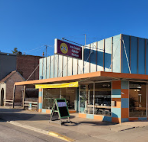 A store front with a sign that says ' smiley face ' on it