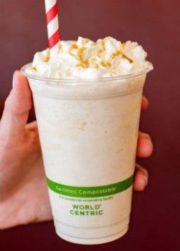 A person is holding a milkshake