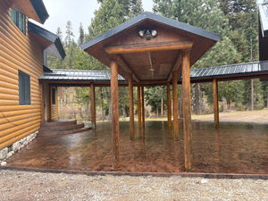 A curved stone walkway with a textured, flagstone pattern runs alongside a patch of green grass.