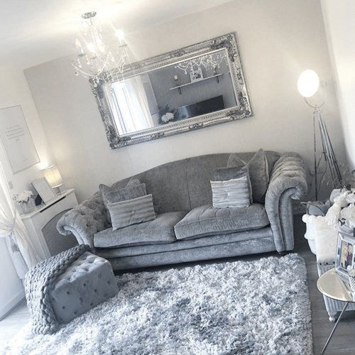 A grey sofa in a white and silver room