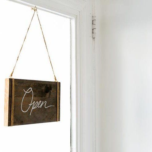 Wooden open sign on a door