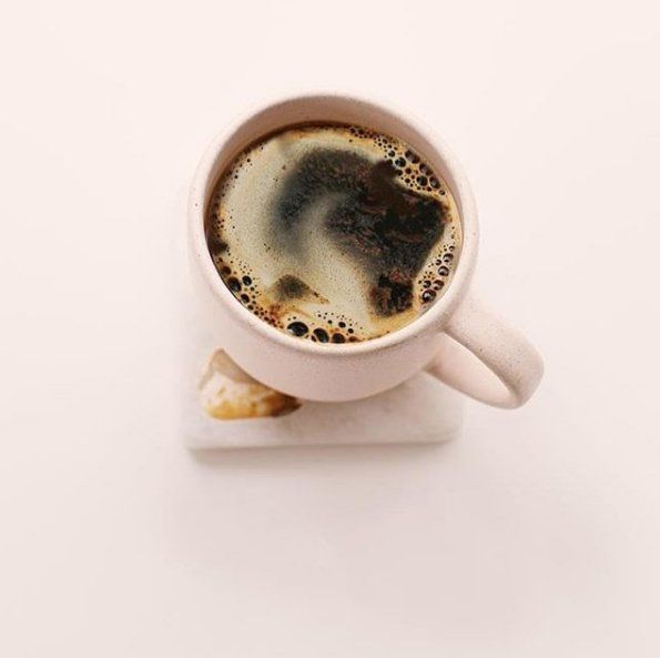 A cup of coffee on a white table