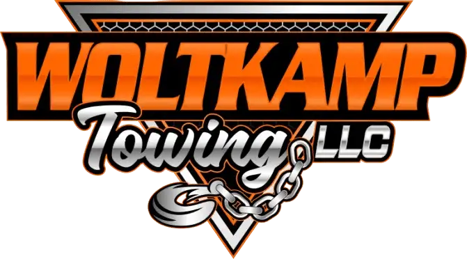 Orange and black logo for Woltkamp Towing LLC, featuring a triangular background, metallic text, and a towing chain hook.