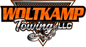 Orange and black logo for Woltkamp Towing LLC, featuring a triangular background, metallic text, and a towing chain hook.