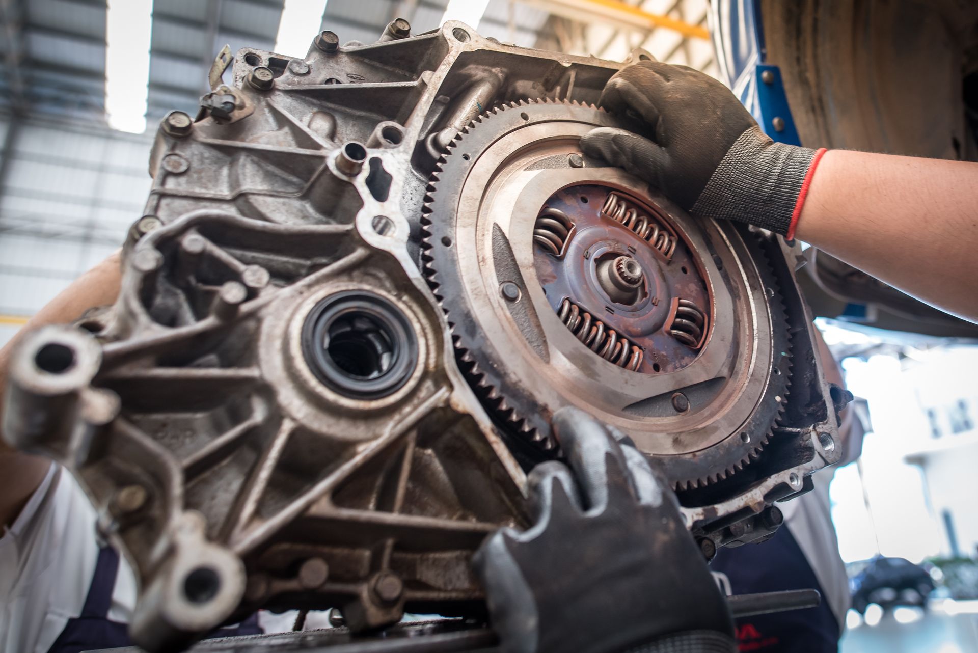 A person is working on a car engine in a garage.