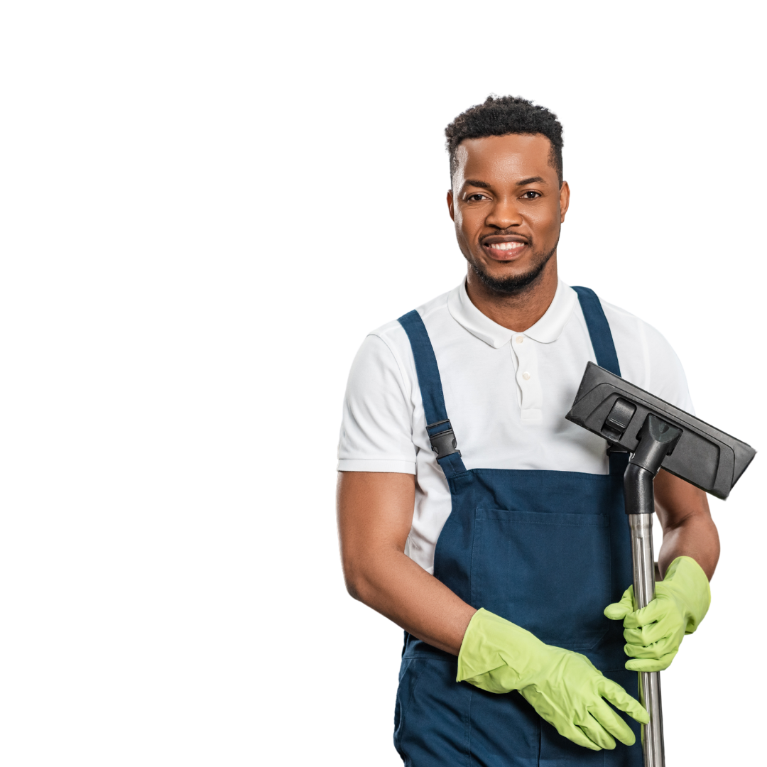 A man in overalls and green gloves is holding a vacuum cleaner.