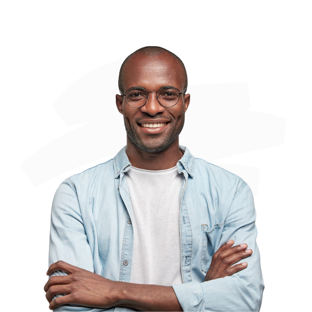 A man wearing glasses and a light blue shirt is standing with his arms crossed and smiling.