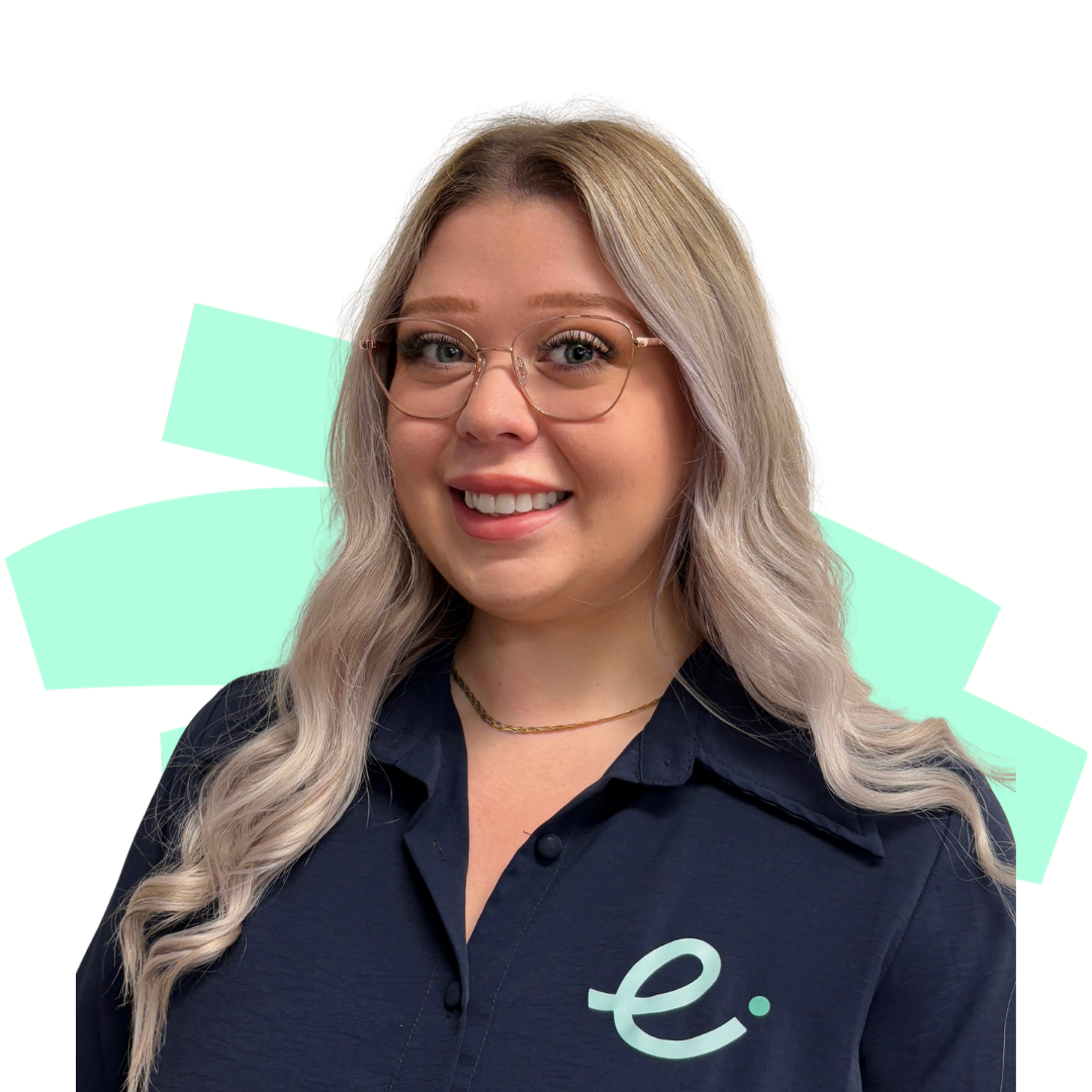 A woman wearing a blue shirt with the letter e on it is smiling.