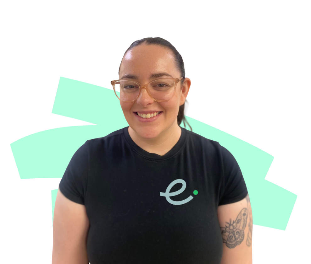 A woman wearing a blue shirt with the letter e on it