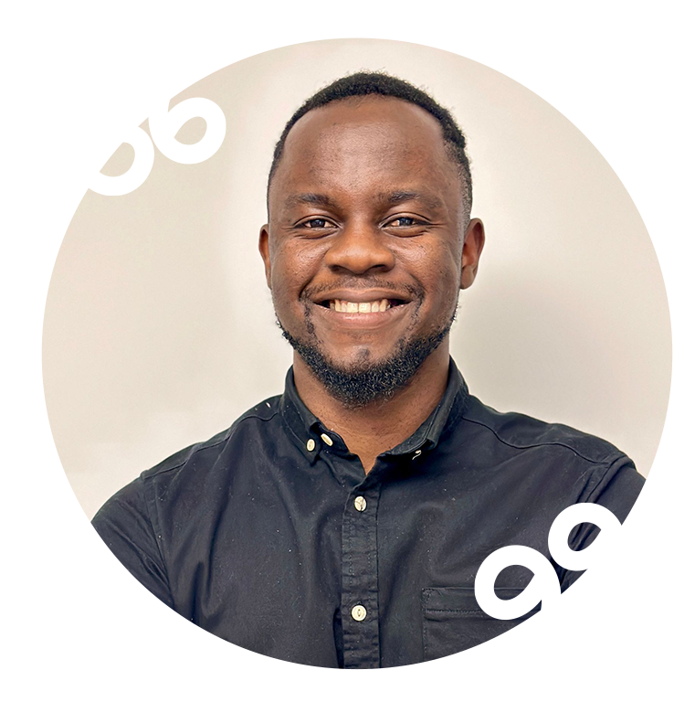 A man in a black shirt is smiling in a circle.