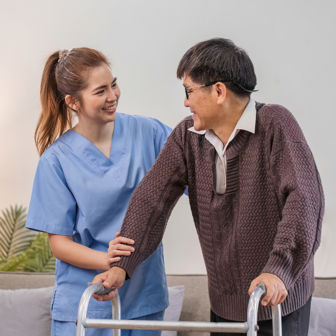 A nurse is helping an elderly man with a walker.