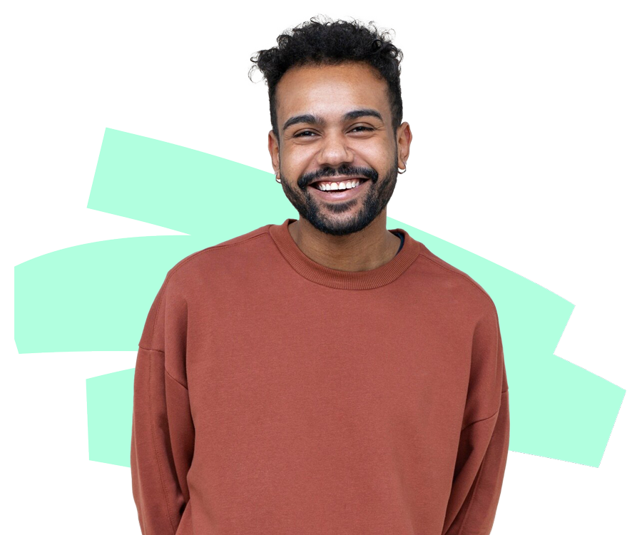 A man with a beard is wearing a brown sweater and smiling.