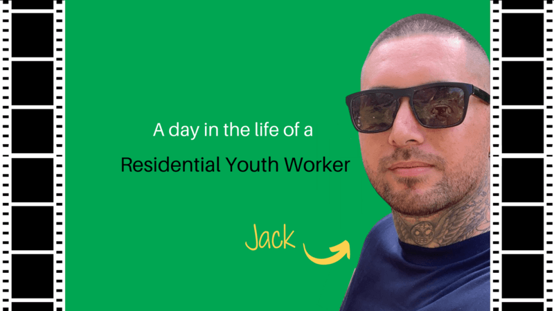 A man wearing sunglasses is standing in front of a green background.