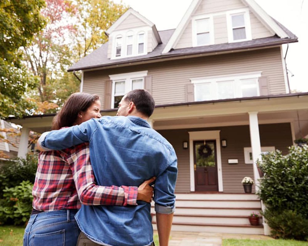 Couple Standing in Front of their New Home — Cartersville, GA — 1st Georgia Home Mortgage