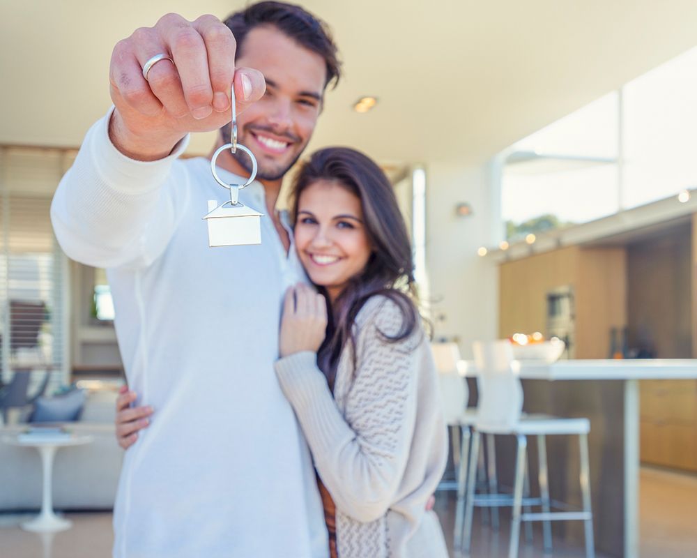 Couple Holding a House Key — Cartersville, GA — 1st Georgia Home Mortgage