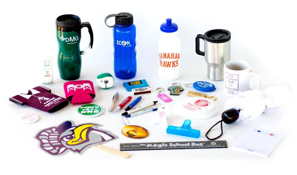 A variety of promotional items are sitting on a table.