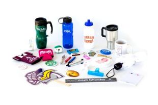 A variety of promotional items are sitting on a table.