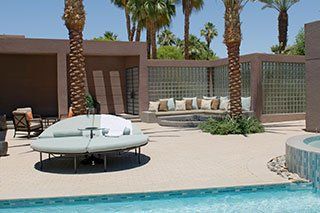 Seating with palm trees on poolside - Home Theater Windows in Cathedral City, CA