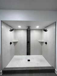 a bathroom with two showers and two shelves