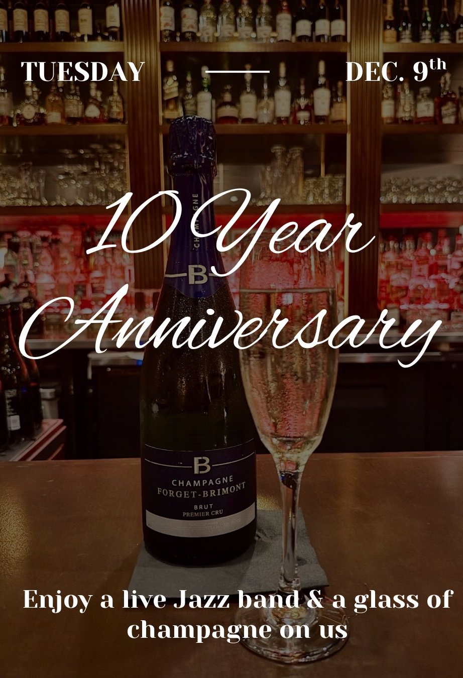 Cheese board with red wine, crackers, and grapes on a wooden table in a restaurant.