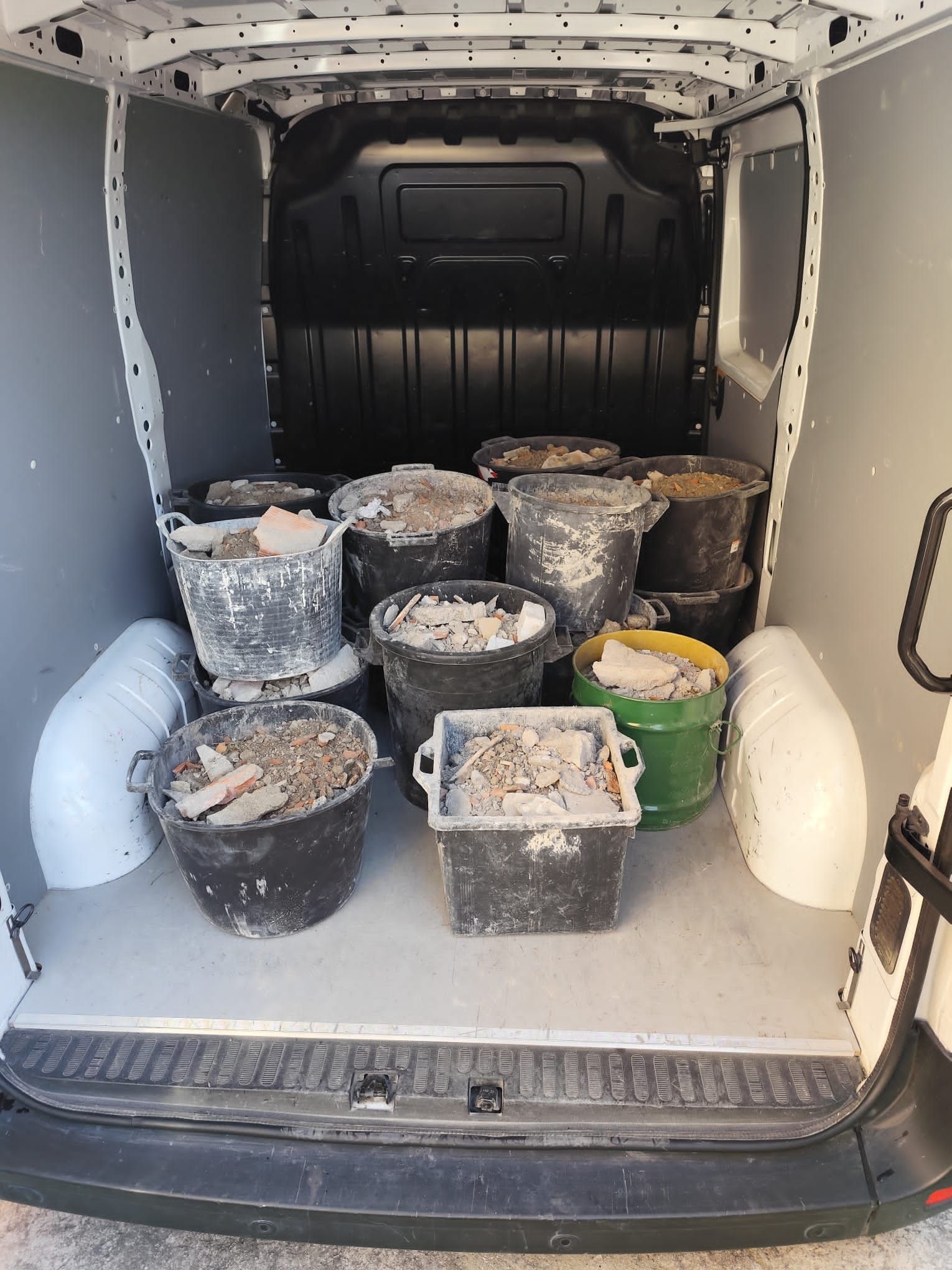L'interno del furgone è pieno di vari secchi contenenti detriti edili.