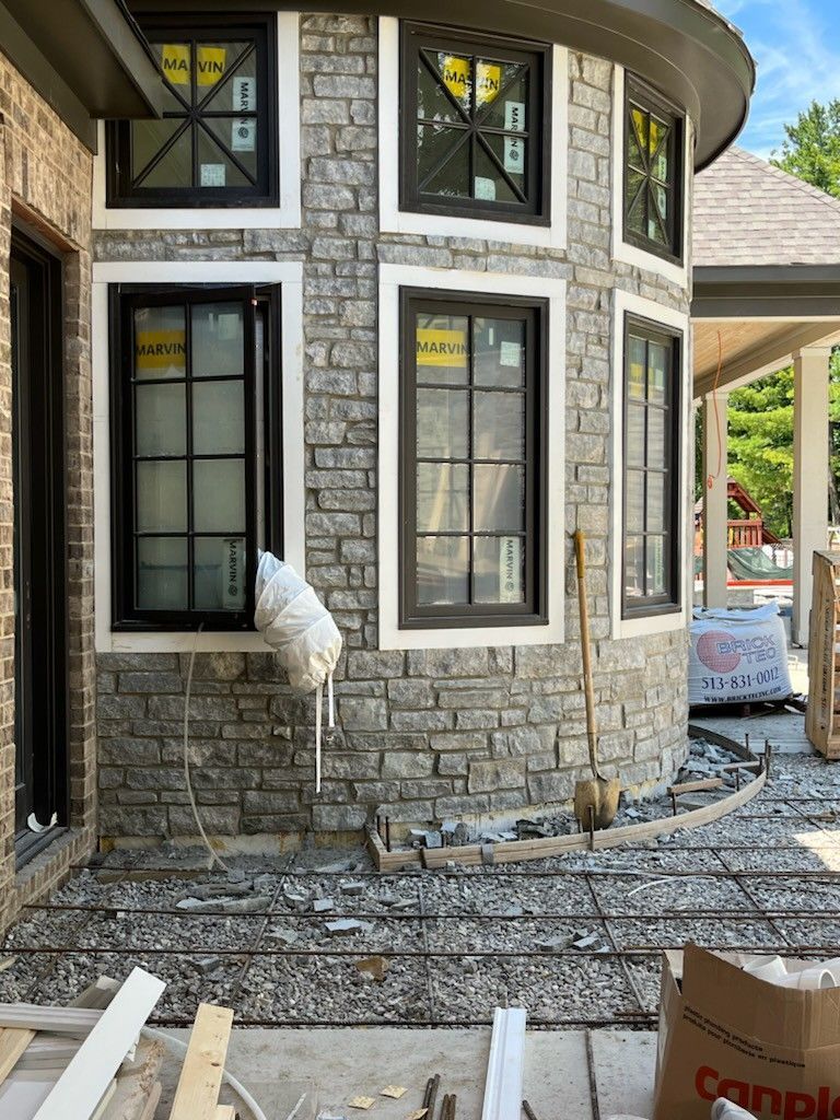 A Stone Walkway Surrounded By Flowers And Plants In A Garden — Dayton, OH — Sharp Edge Landscaping And Lawncare LLC