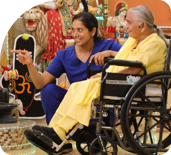 Nurse with patient in a wheelchair - cultural program - Indian Nursing Program
