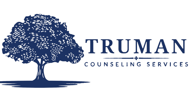 The logo for truman counseling services has a tree on it.