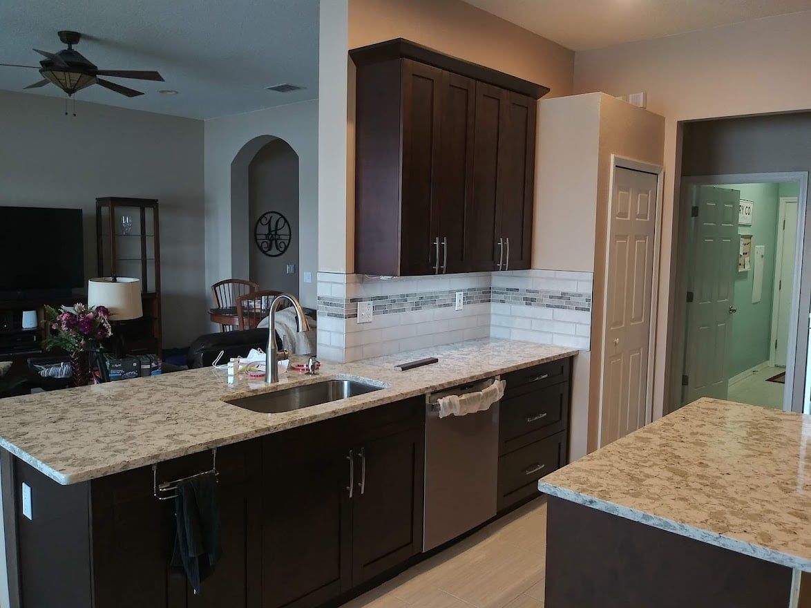 A kitchen with stainless steel appliances and granite counter tops.