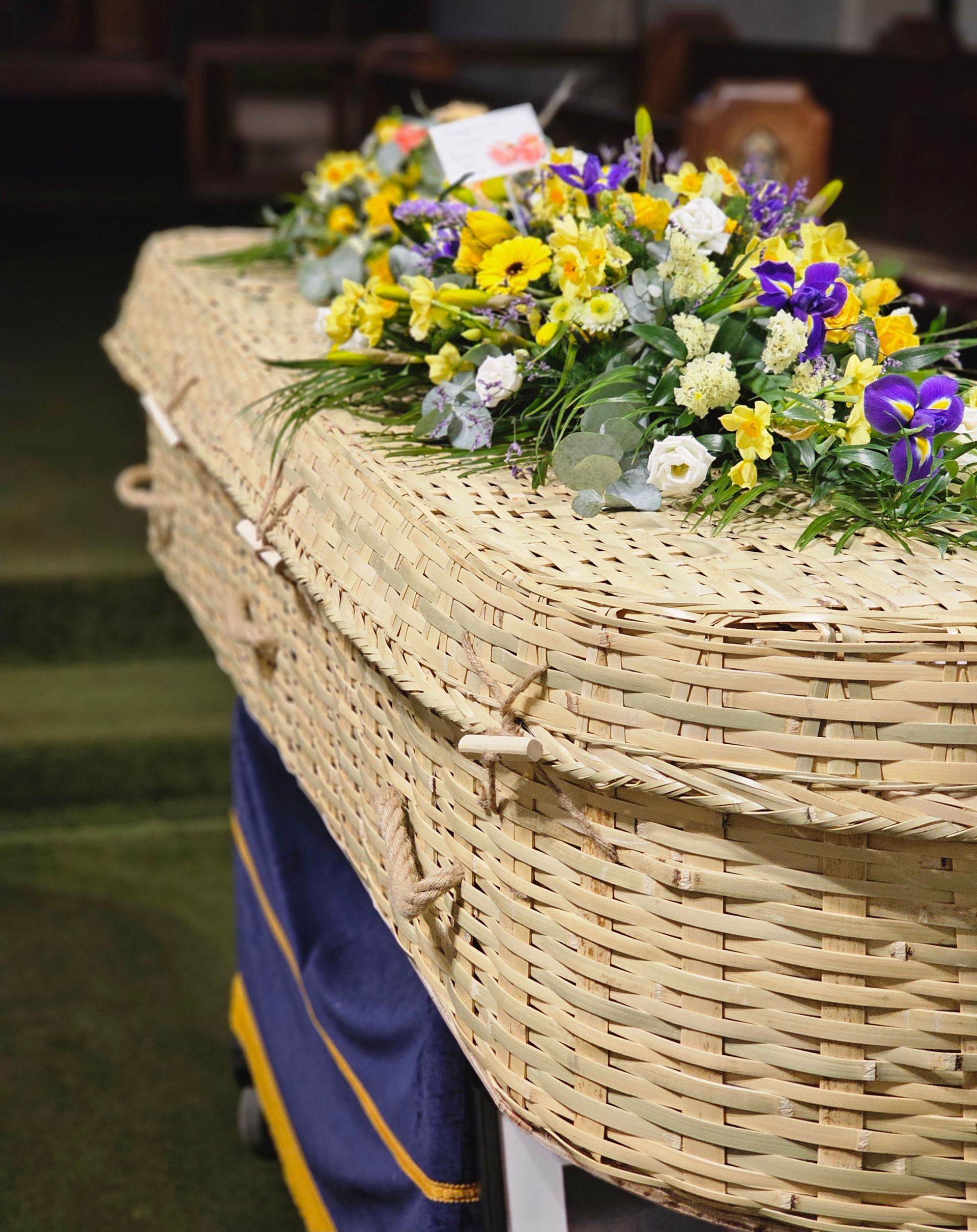 There is a statue in the middle of a garden in front of a house.
