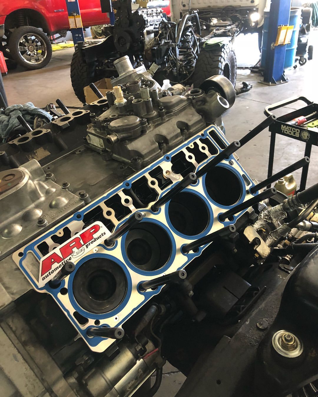 A car engine is being worked on in a garage.
