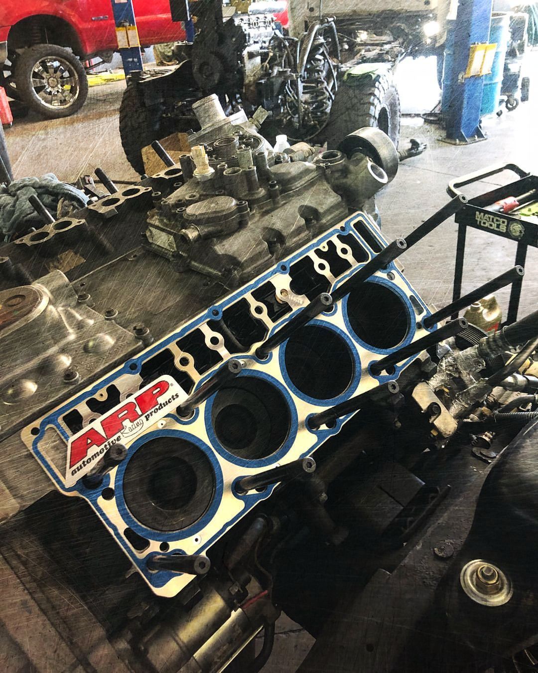 A car engine is being worked on in a garage.