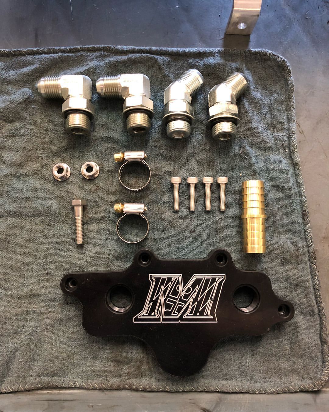 A bunch of metal parts are sitting on a towel.