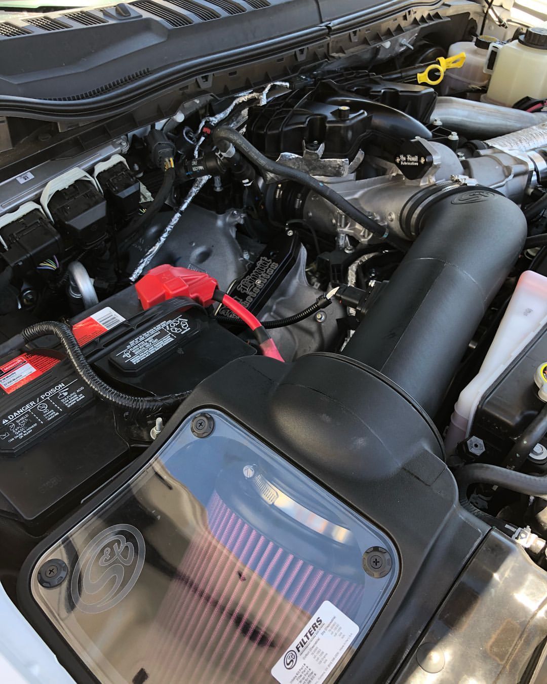 A close up of a car engine with a filter in it.